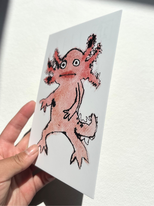 A6 postcard featuring a vivid hand draw watercolour illustration of a cartoon Axolotl.