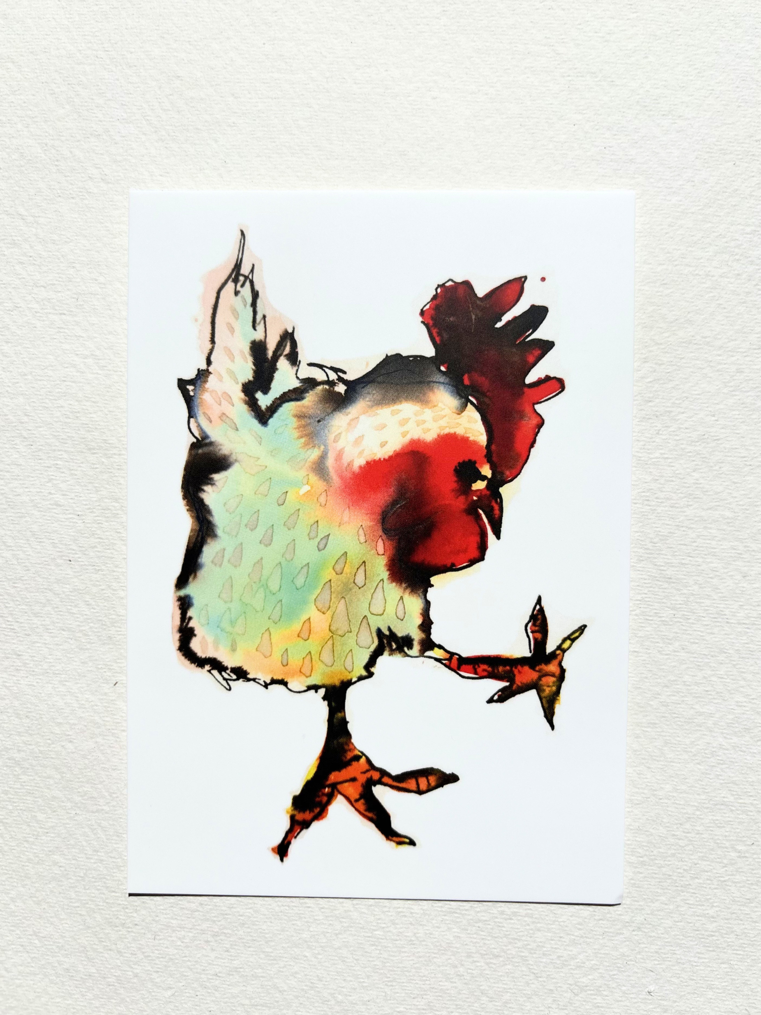  A6 postcard featuring a hand draw vivid watercolour illustration of a cartoon Cockerel.